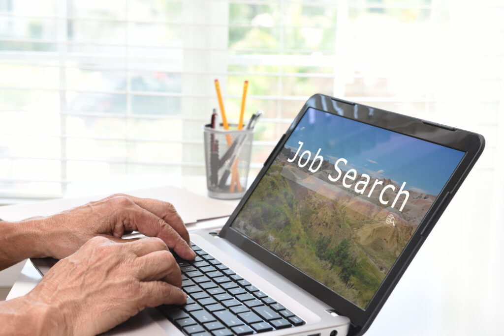 A man job hunting on his laptop.